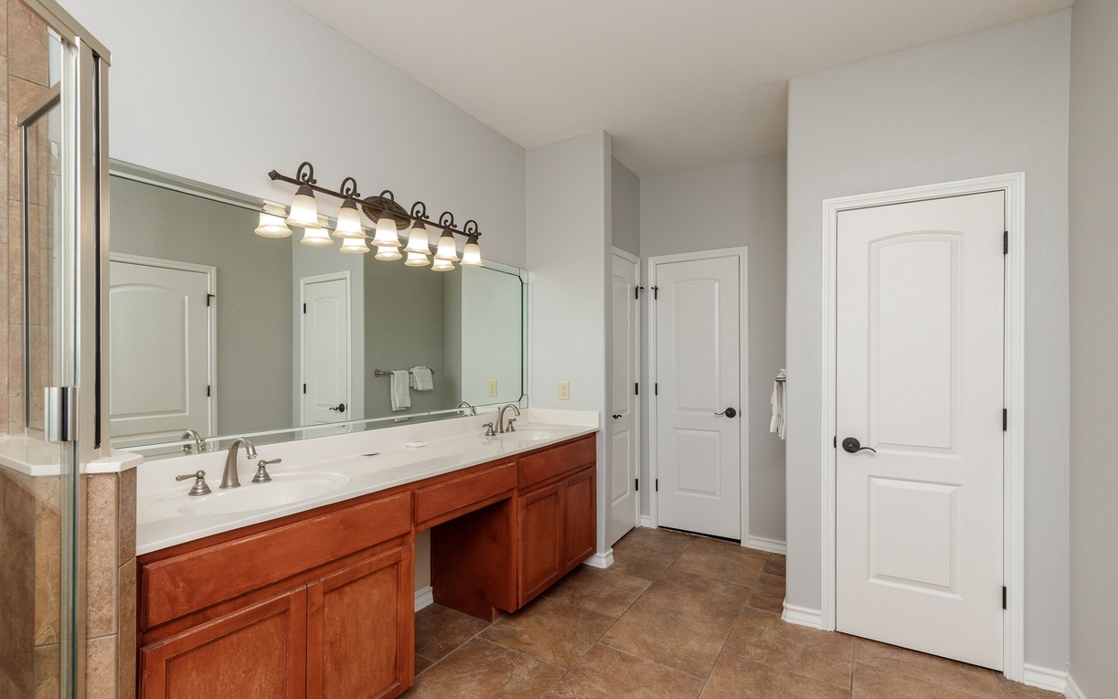 Freshen up in your spacious master bathroom with dual vanities and elegant lighting for your morning routine.