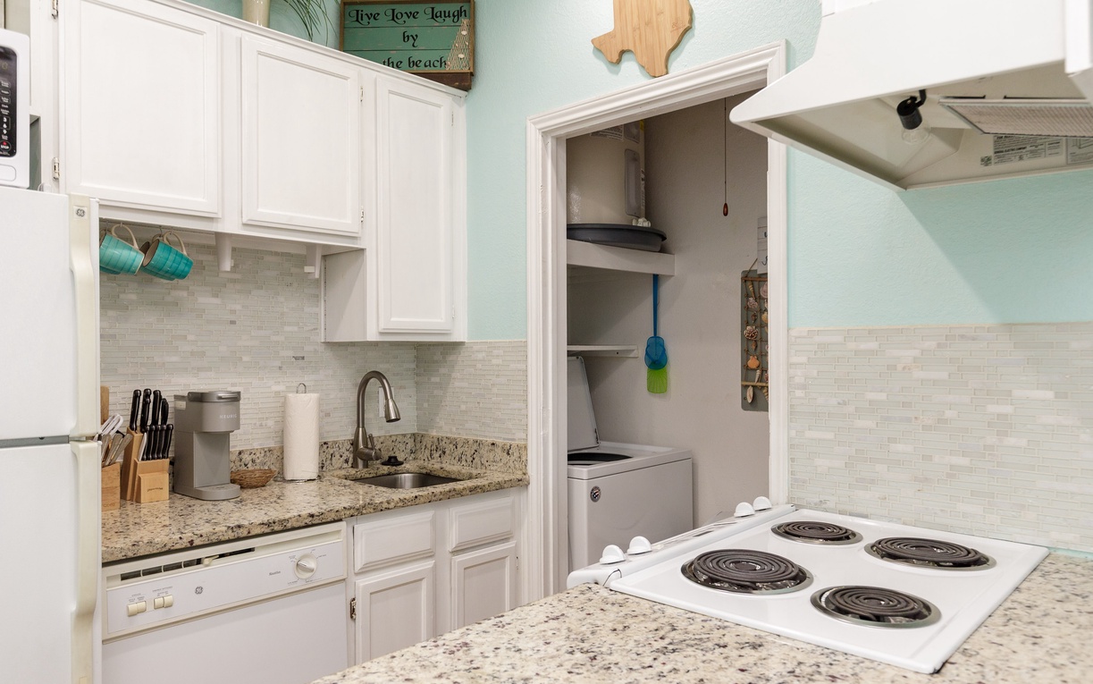Your fully-equipped kitchen awaits with granite counters, white cabinets, and all essentials for preparing your favorite meals during your stay.
