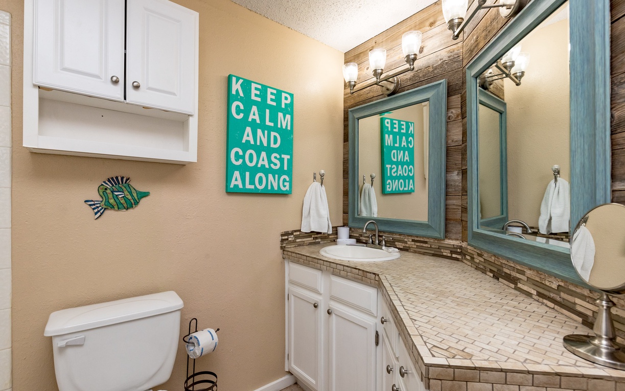 Unwind in your coastal-themed bathroom with beach-inspired décor, dual vanity, and fresh towels waiting for your arrival.