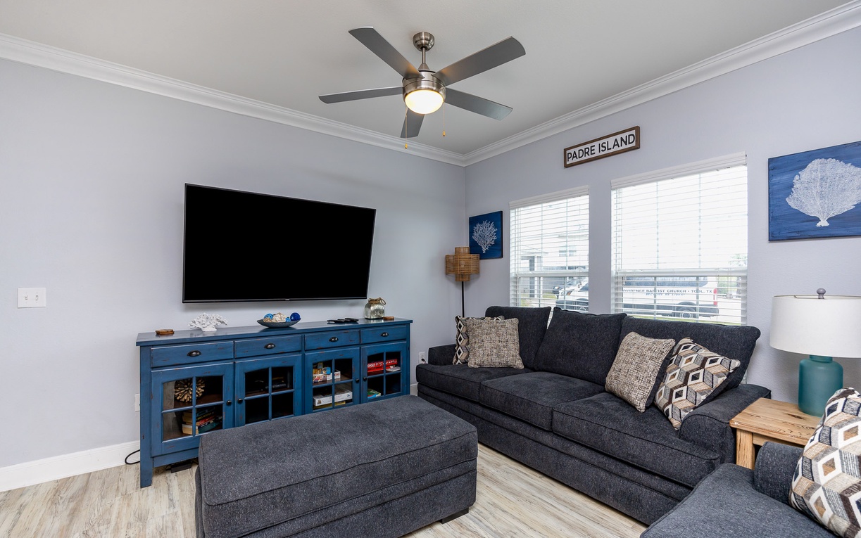 Sink into plush seating while your favorite shows play on the large TV in this coastal-themed living room.