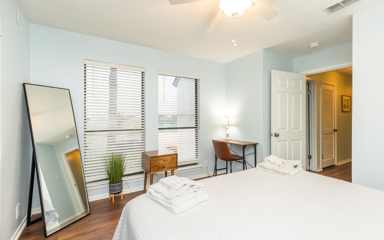 Drift off in your serene bedroom with a queen size bed, natural light, and fresh towels waiting for your arrival.