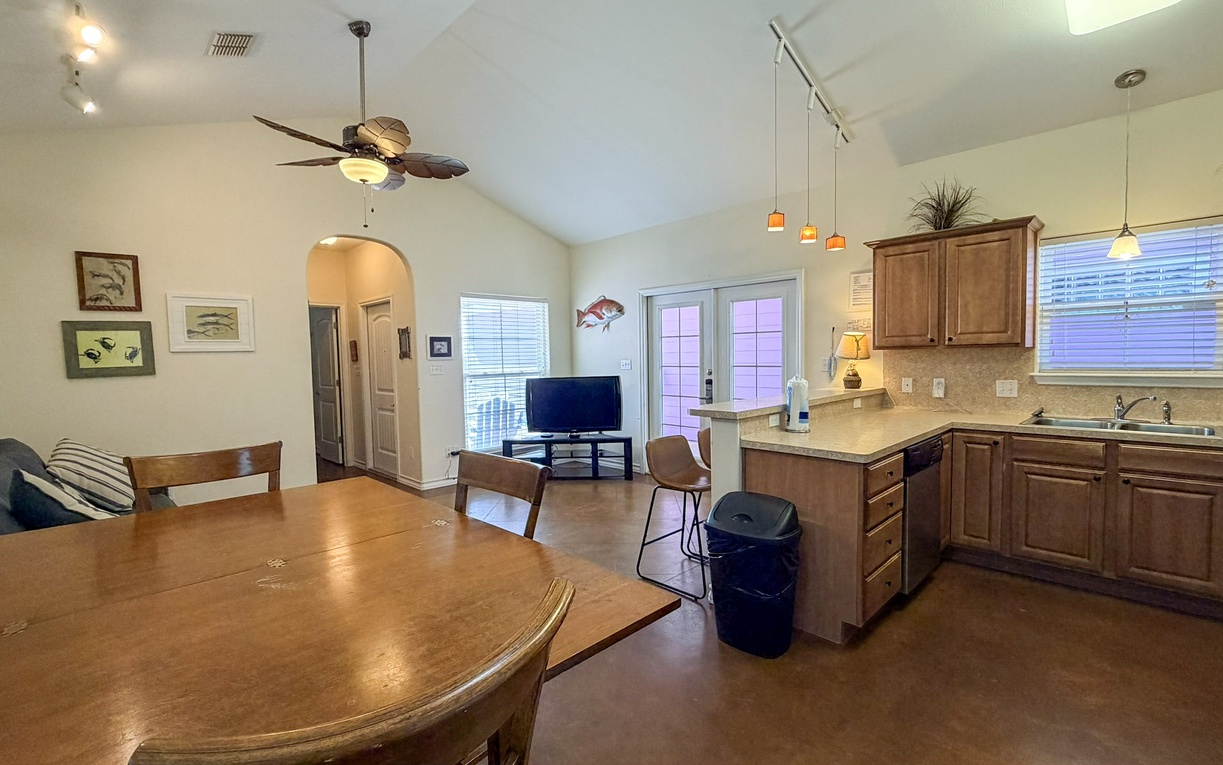 Gather around your spacious dining table while meals simmer in your fully equipped kitchen. The open layout connects you to cozy seating and entertainment.