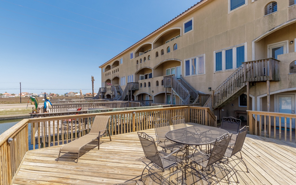 Relax on your private waterfront deck with outdoor dining and lounge chairs overlooking peaceful canal views.