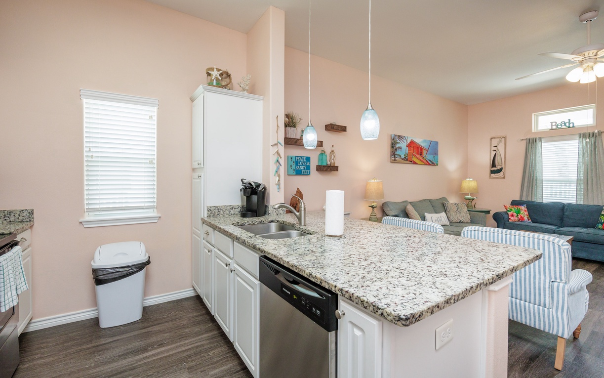 Your spacious kitchen island becomes the heart of your stay, perfect for preparing meals while chatting with loved ones in the cozy living area.