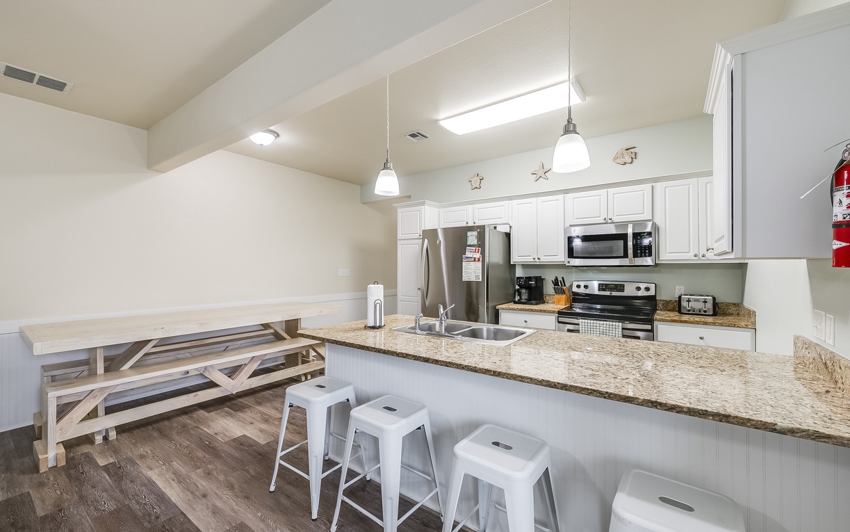 Your fully equipped kitchen features granite counters, stainless appliances, and a breakfast bar where you can sip morning coffee.