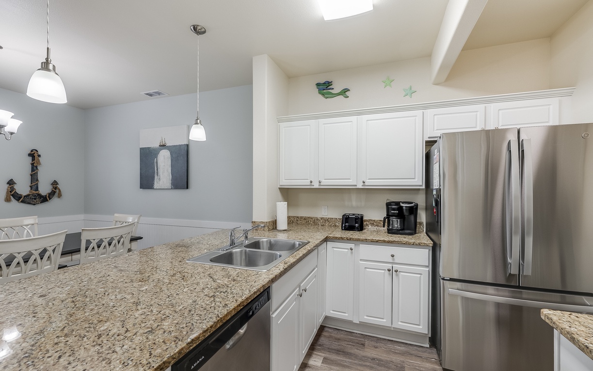 Your modern kitchen awaits with gleaming granite counters, stainless appliances, and coastal charm for memorable meal prep.