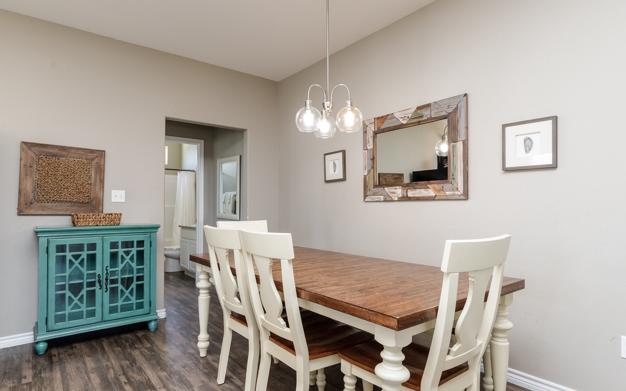 Share memorable meals at your rustic farmhouse dining table, where warm wood tones and coastal charm create the perfect gathering space.