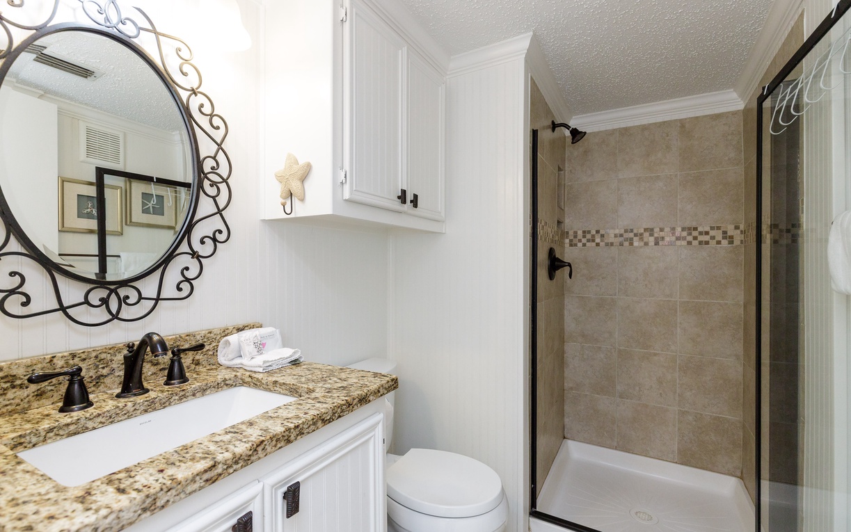 Step into your elegant bathroom with granite counters, spacious shower, and coastal charm - your perfect retreat for refreshing mornings.