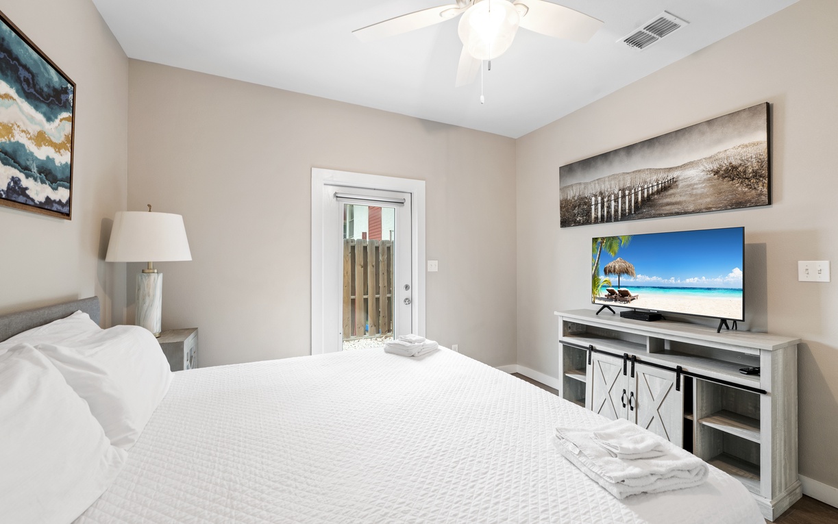 Rest peacefully in your serene bedroom with a plush bed, calming decor, and your own private entrance to an outdoor patio area.