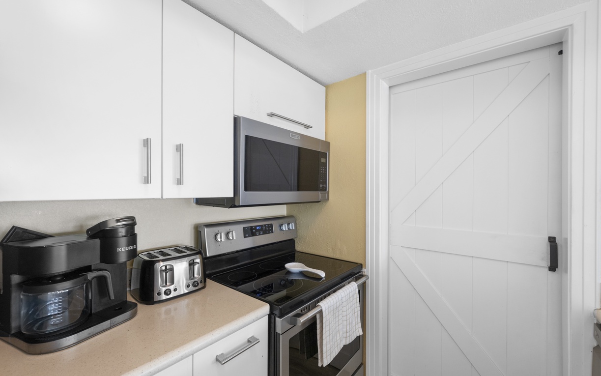 Your fully equipped kitchen awaits with modern appliances, coffee maker, and everything needed to prepare meals during your stay.