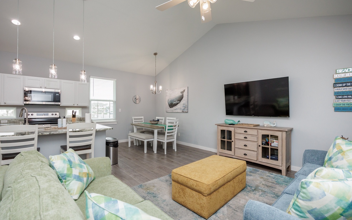 Unwind in your bright open living space with comfortable seating, modern kitchen, and coastal-inspired décor.