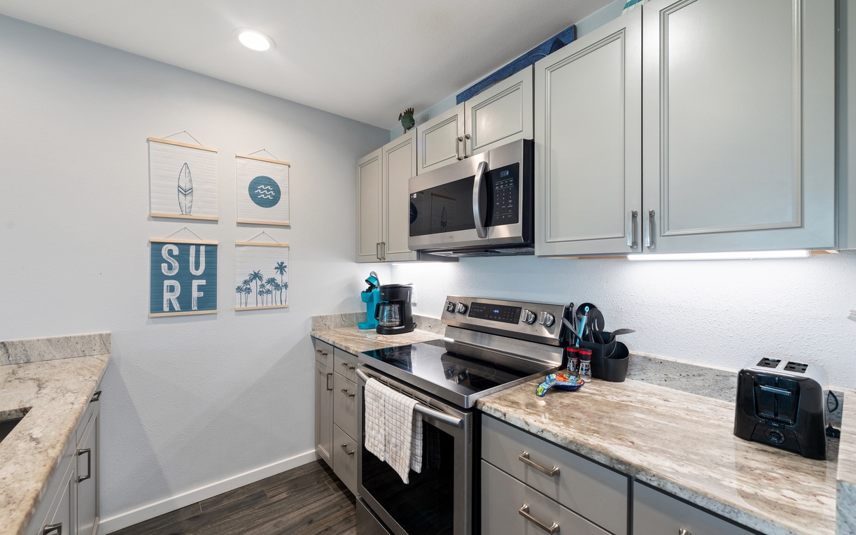 Your fully equipped kitchen awaits with sleek granite countertops, modern appliances, and coastal charm. Brew your morning coffee and whip up favorite meals in this bright, beachside space.