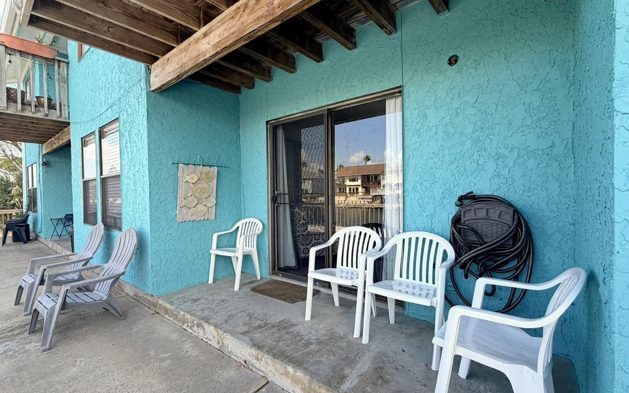 Relax in colorful Adirondack chairs on your private covered patio, where exposed wooden beams create rustic charm for morning coffee or evening conversations.