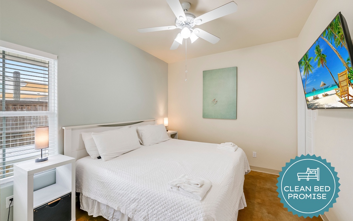 Drift into sweet dreams on crisp white linens while your ceiling fan creates the perfect breeze in your peaceful bedroom retreat.
