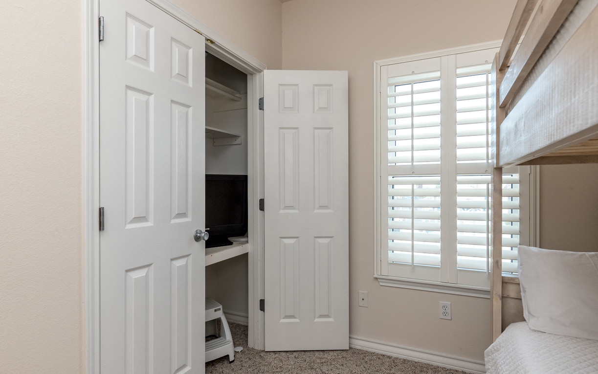 Cozy bunk room with built-in beds and ample closet storage for your belongings.