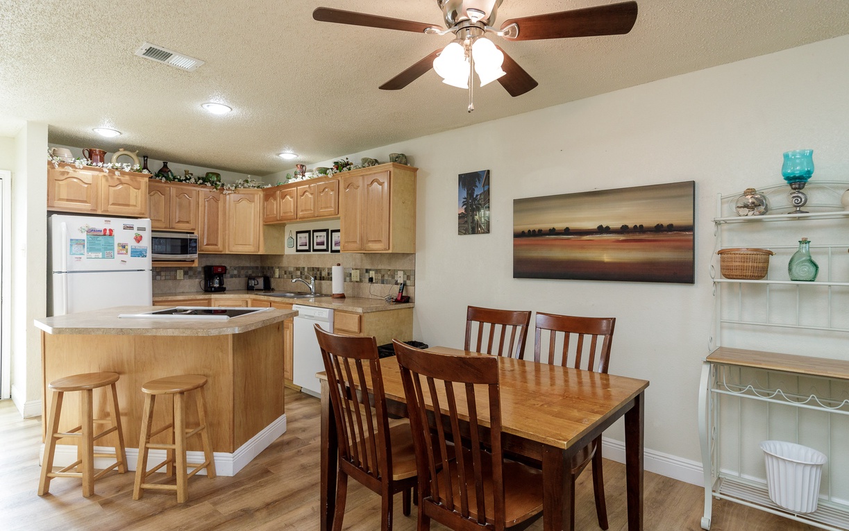 Your spacious kitchen invites home-cooked meals with warm wood cabinets, modern appliances, and a cozy dining nook for memorable moments.