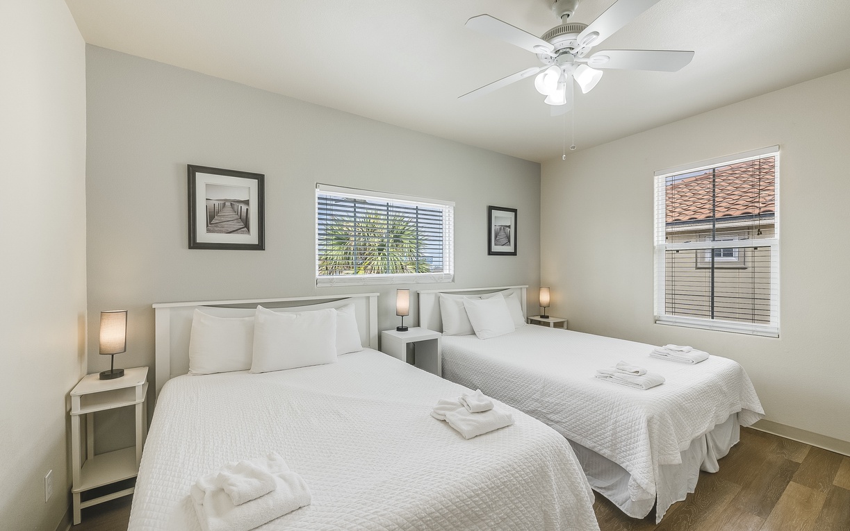 Drift off to sleep in your peaceful twin bedroom with crisp linens, gentle ceiling fan, and warm natural light.