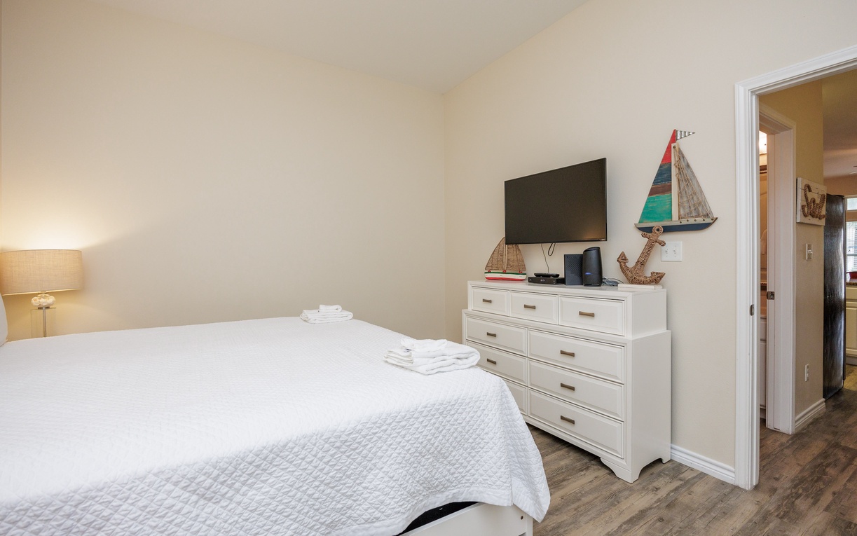Rest comfortably in your coastal-themed bedroom with fresh linens, smart TV, and charming nautical touches creating a peaceful seaside retreat.