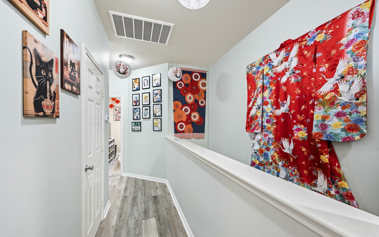 A bright hallway adorned with a Japanese wedding robe and Anime artwork handcrafted by owner. The eclectic mix of colors and textures adds personality to your stay.