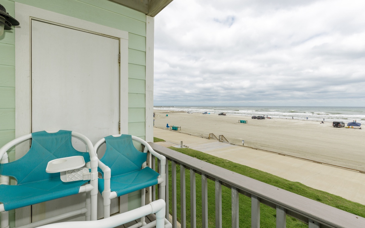 Relax on your private beachfront balcony with stunning ocean views and comfortable seating just steps from the sand.