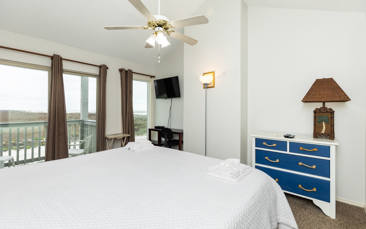 Wake up to stunning views in your airy bedroom, where coastal breezes from the ceiling fan and natural light create the perfect retreat for restful nights.