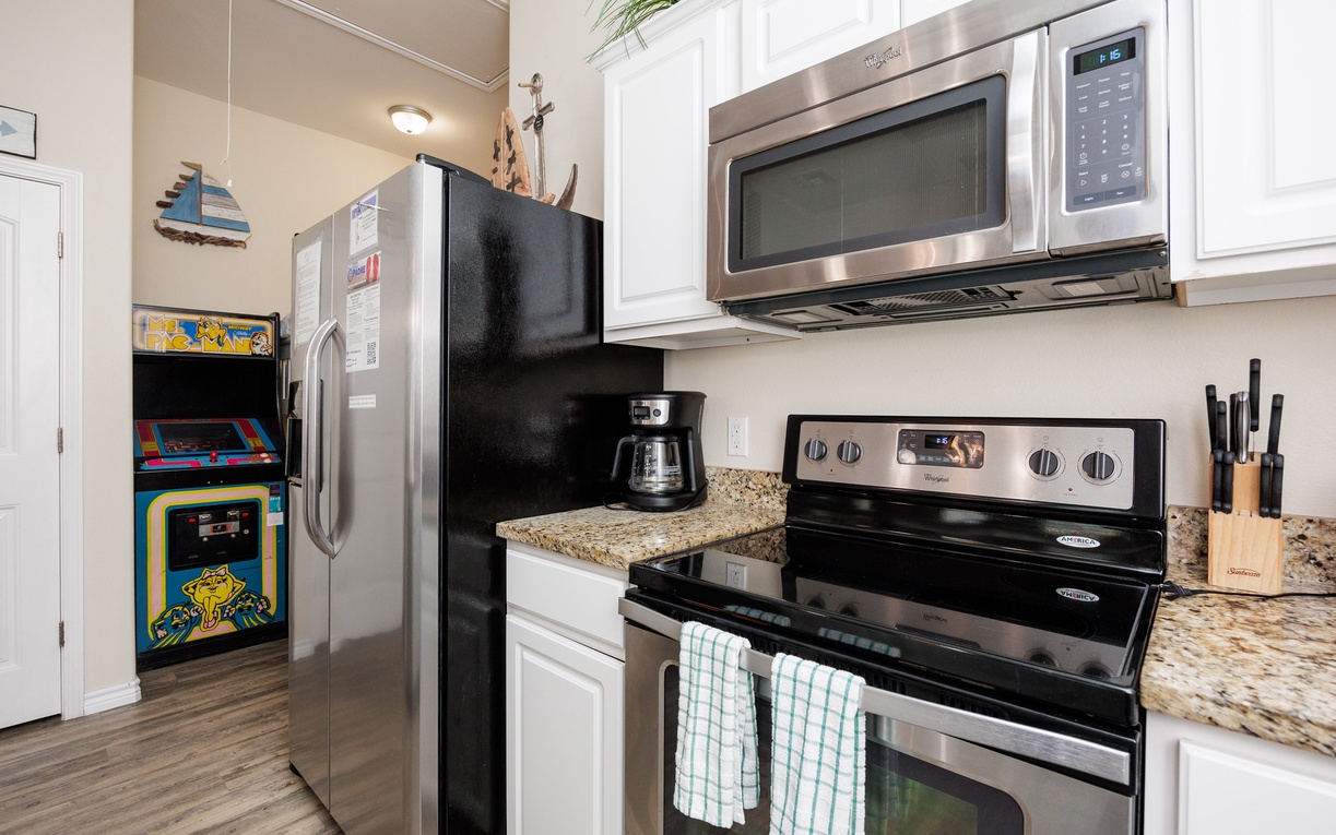 Your fully equipped kitchen features stainless steel appliances and granite countertops, plus a fun arcade game for entertainment between meals.
