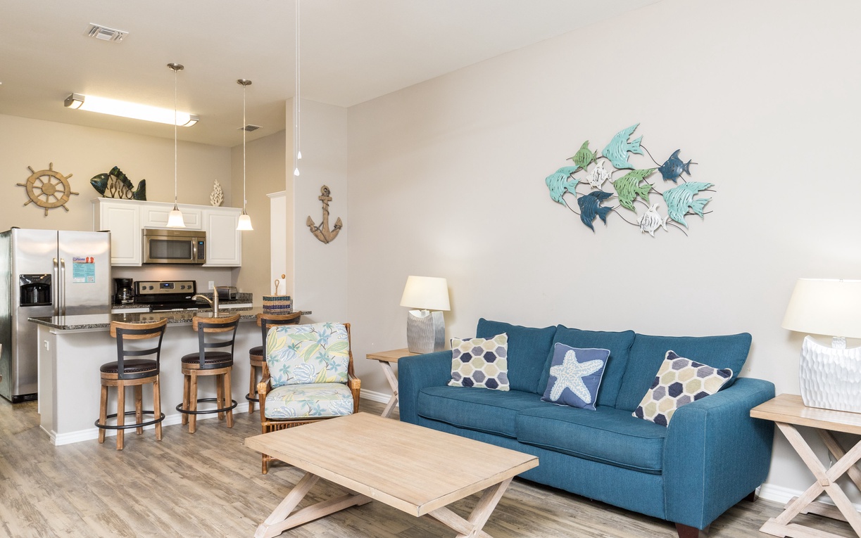 Your coastal-themed living space features nautical décor and an open kitchen, perfect for relaxing after beach adventures.