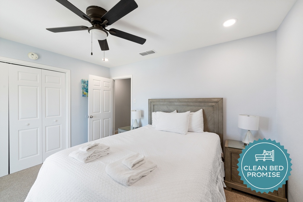 Settle into the inviting guest bedroom featuring a comfortable queen bed, crisp linens, and a bright, relaxing atmosphere.