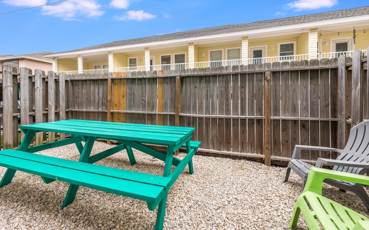 Your private outdoor space features colorful seating where you can enjoy morning coffee or evening meals in the fresh air.