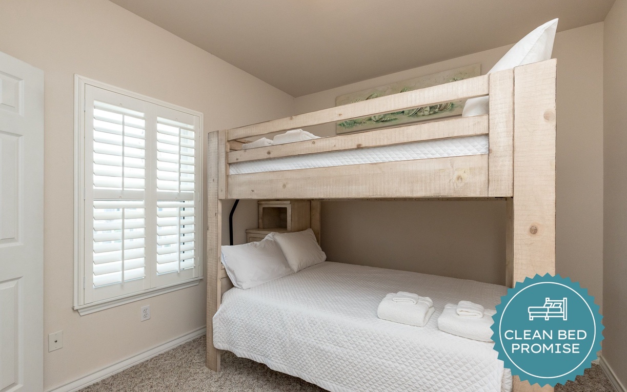 Your cozy bunk bedroom offers comfortable sleeping for the whole family, with soft linens and natural light streaming through plantation shutters.