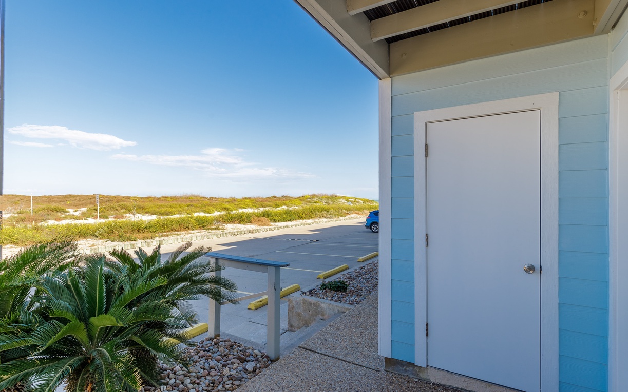 Covered patio with coastal views and ping pong table offers the perfect spot to relax and play while enjoying ocean breezes.