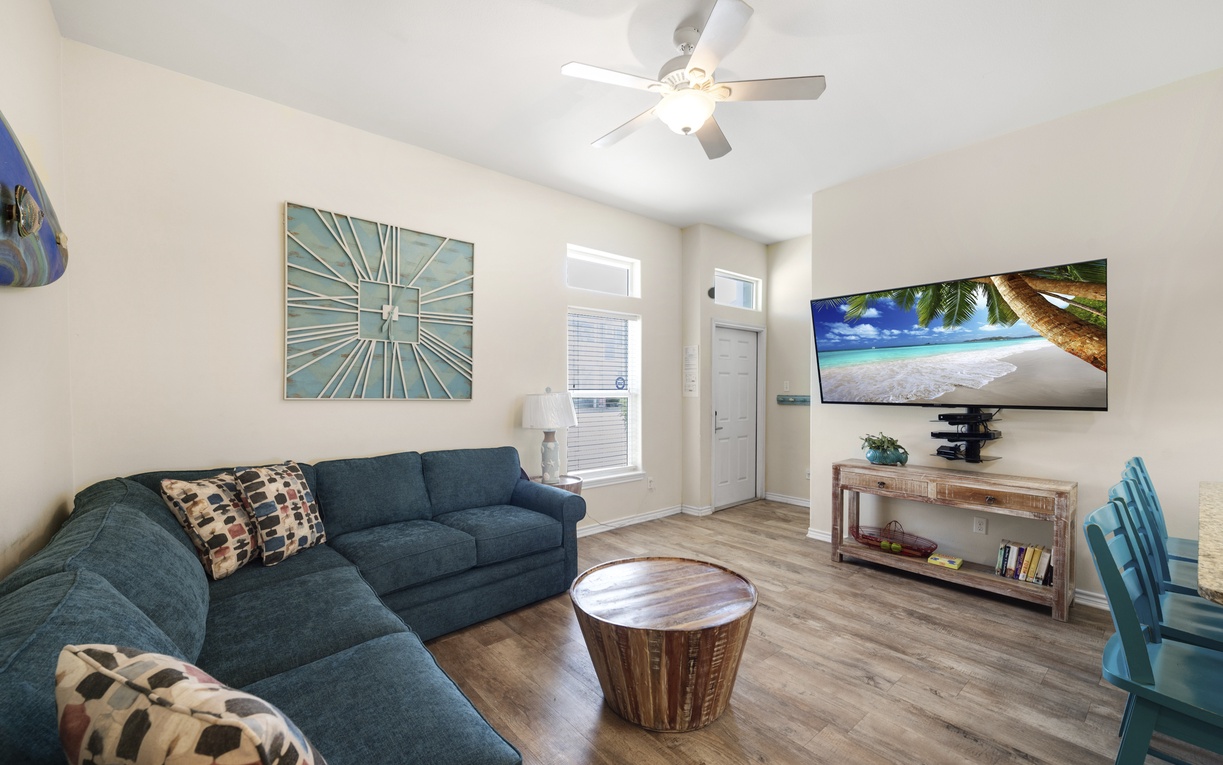 Unwind in your bright, coastal-themed living room with plush sectional seating and tropical decor that makes relaxation effortless.