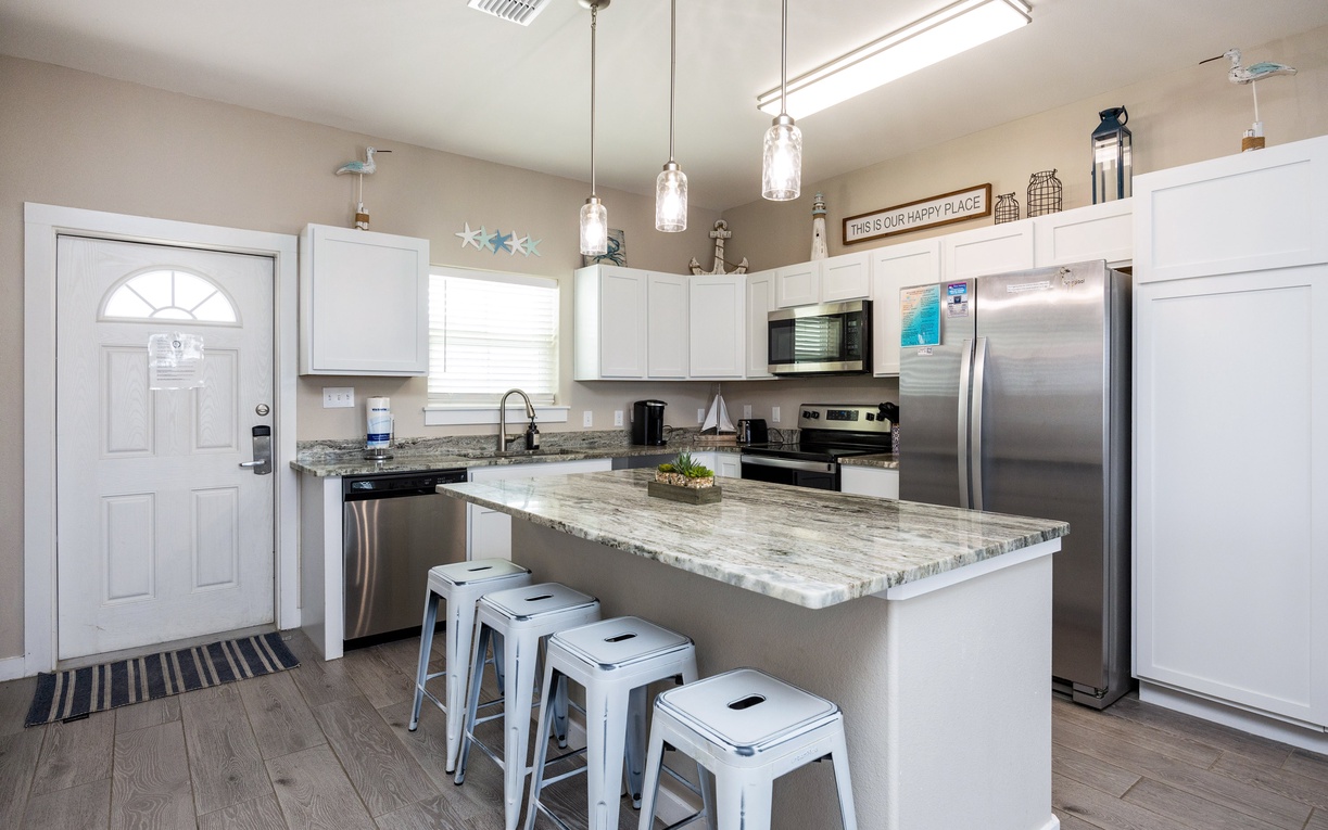 Cook your favorite meals in this bright modern kitchen with granite countertops, stainless appliances, and bar seating for casual dining.