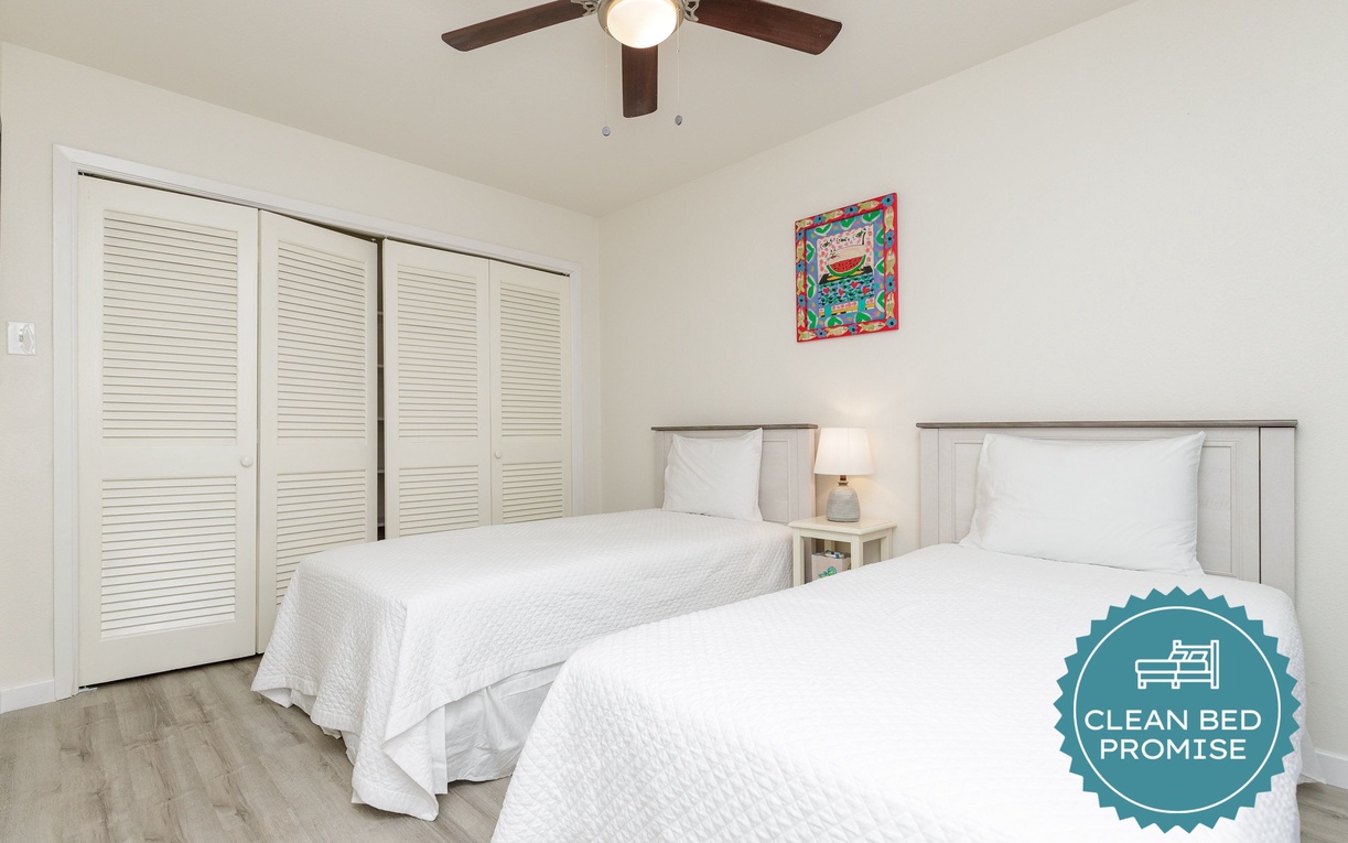 Drift off to sleep in your peaceful twin bedroom, where crisp linens and gentle ceiling fan breezes create the perfect restful retreat.