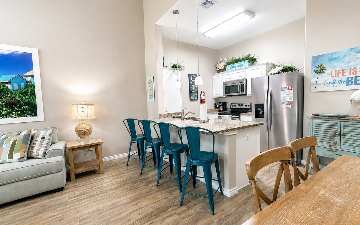 Enjoy the bright, open living and dining area, where coastal décor and comfortable seating create a welcoming space to gather and relax.