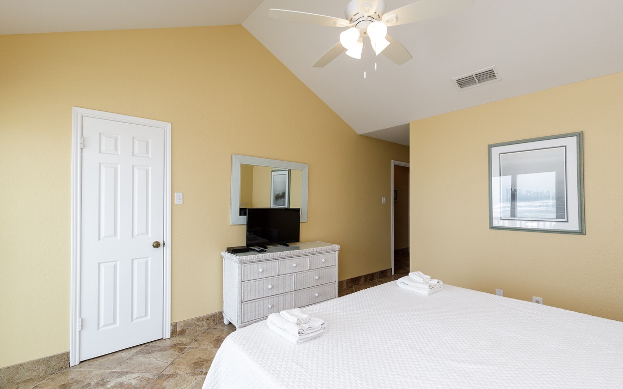 Your comfortable bedroom features crisp linens, a ceiling fan for gentle breezes, and a flat-screen TV for relaxing evenings.