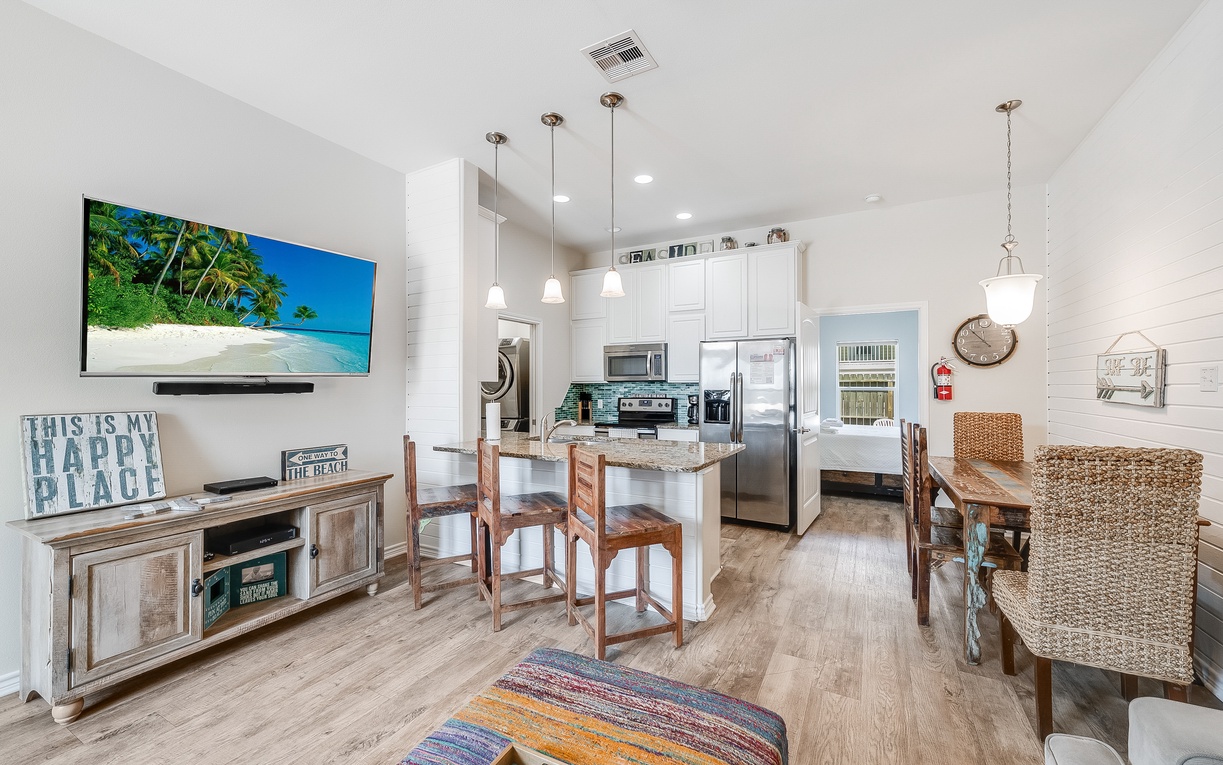 Unwind in your stylish open-concept space where coastal vibes meet modern comfort, featuring a gourmet kitchen perfect for creating vacation memories.