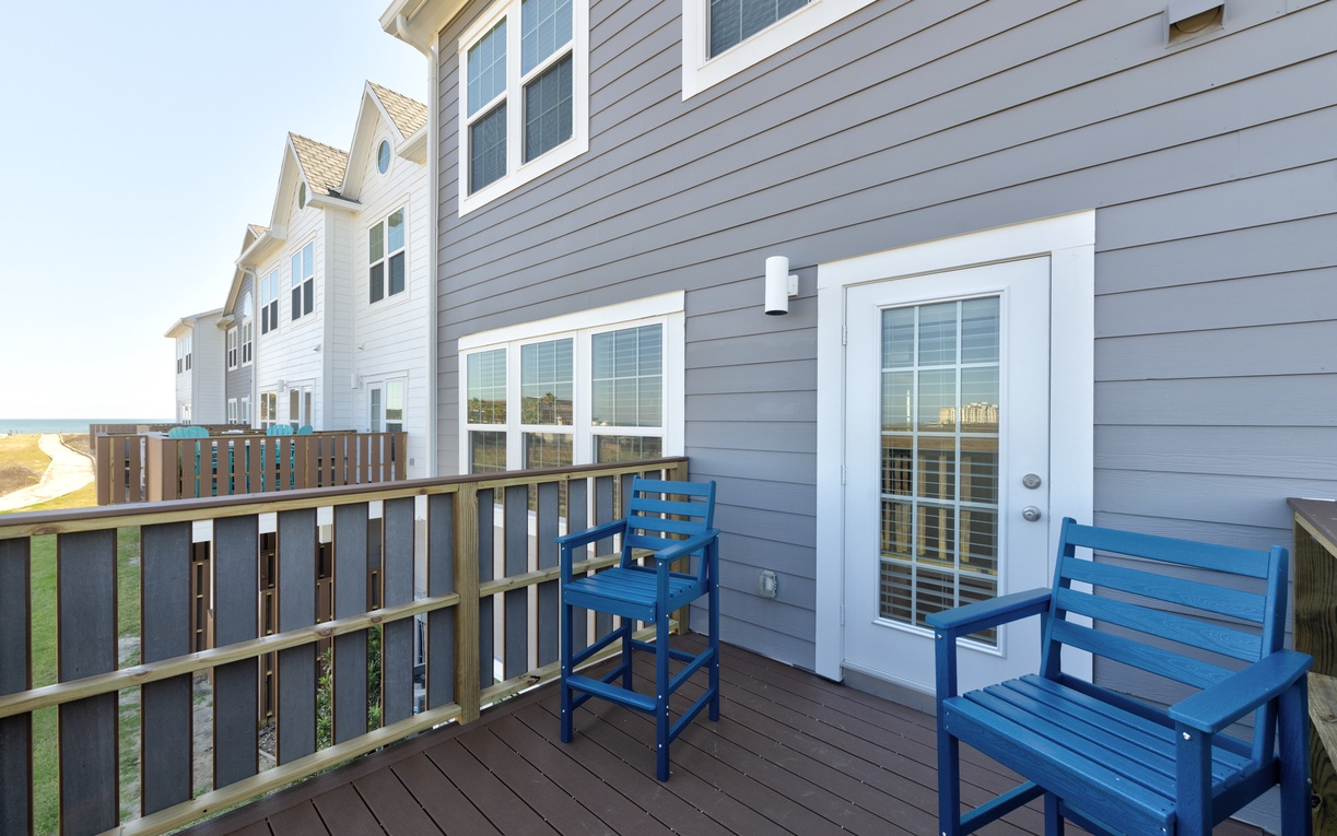 Step onto your private balcony and settle into the blue chairs for morning coffee or evening relaxation overlooking the peaceful neighborhood.