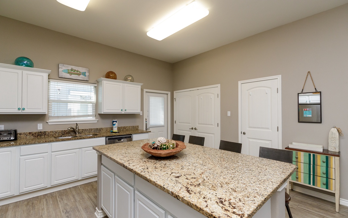 Cook memorable meals in your spacious kitchen featuring granite countertops, crisp white cabinetry, and a generous island perfect for gathering.