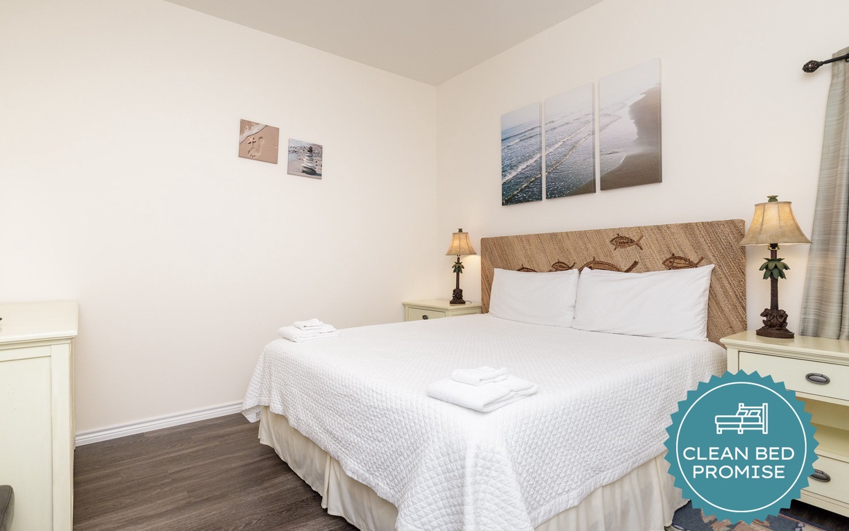Sink into crisp white linens and rest your head on the woven headboard in this peaceful bedroom retreat.