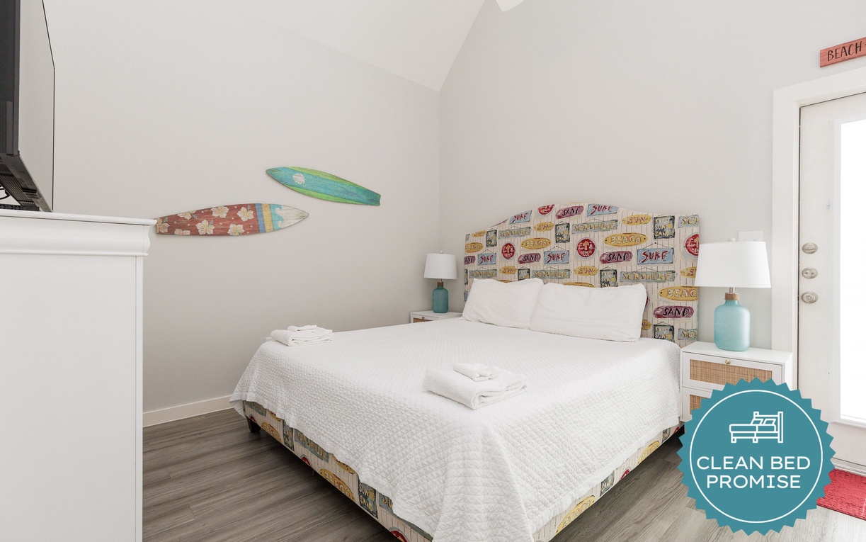 Drift off in this charming coastal-themed bedroom with surfboard art, crisp white linens, and beachy touches that make your seaside getaway complete.
