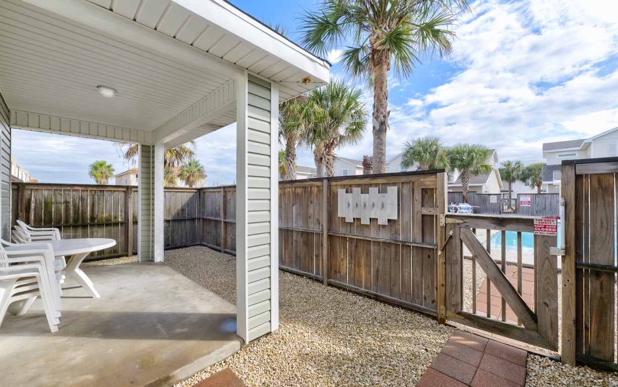 Step onto your private covered patio where coastal breezes meet comfortable seating—perfect for morning coffee or evening relaxation.