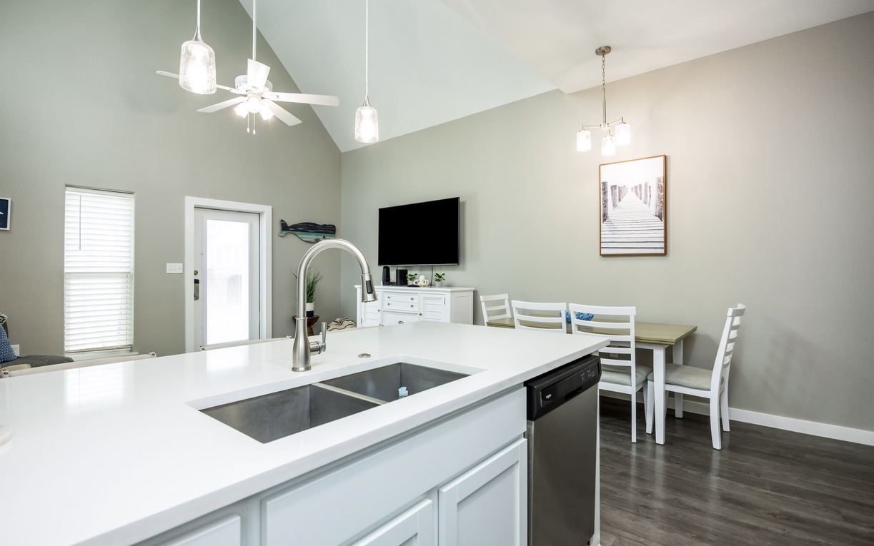 Your open-concept kitchen and dining area features modern appliances, elegant pendant lighting, and a spacious island perfect for cooking together.