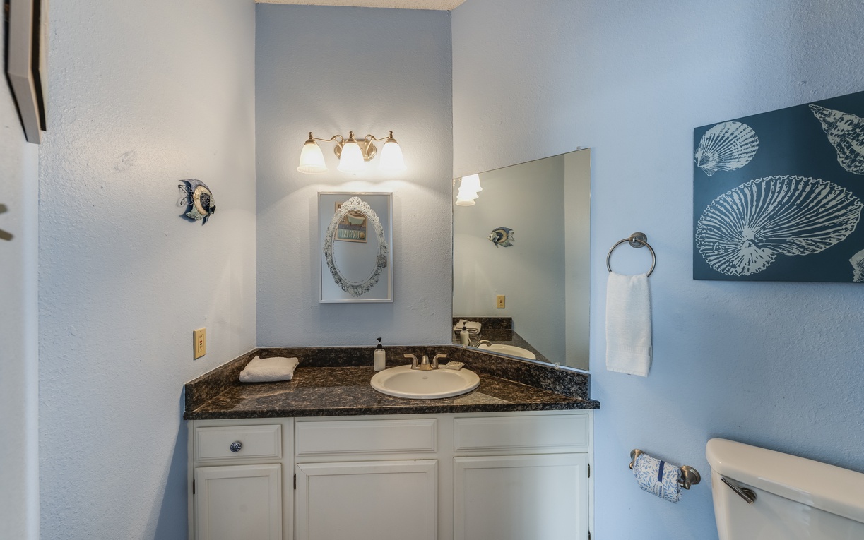 Private en-suite bathroom with granite countertops, generous vanity space, and bright lighting to help you get ready with ease.