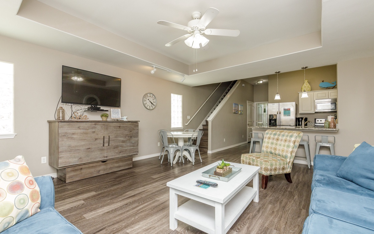 Unwind in your spacious open-plan living area with comfortable seating and modern amenities for the perfect home-away-from-home experience.
