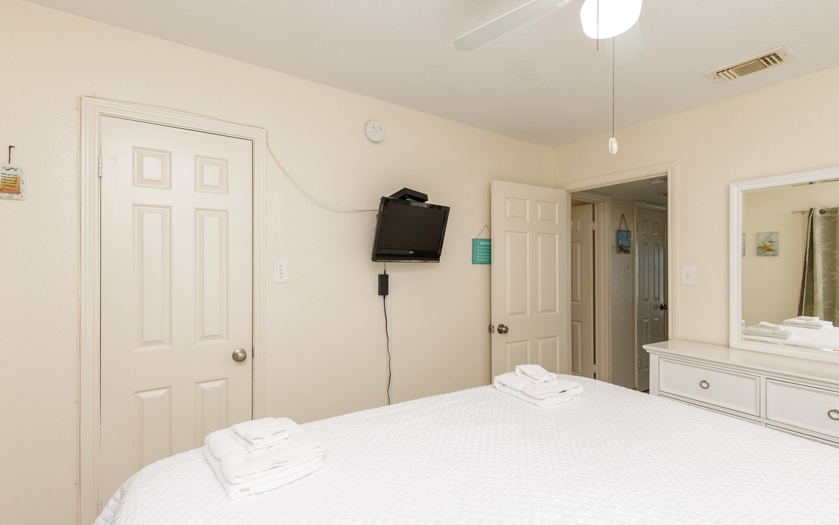 Relax in your comfortable bedroom with crisp linens, convenient TV, and ensuite bathroom access for a restful stay.