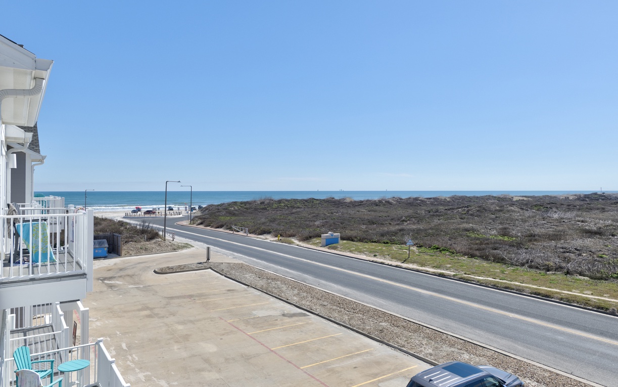 Coastal property with sea views across natural dunes and convenient road access to nearby beaches.