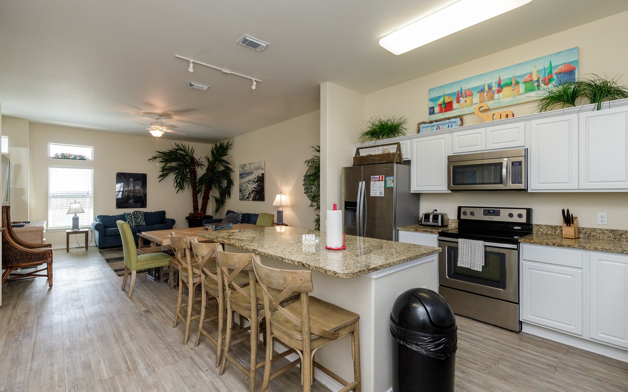 Your open-concept kitchen flows seamlessly into the living area, perfect for cooking while chatting with family around the granite island.