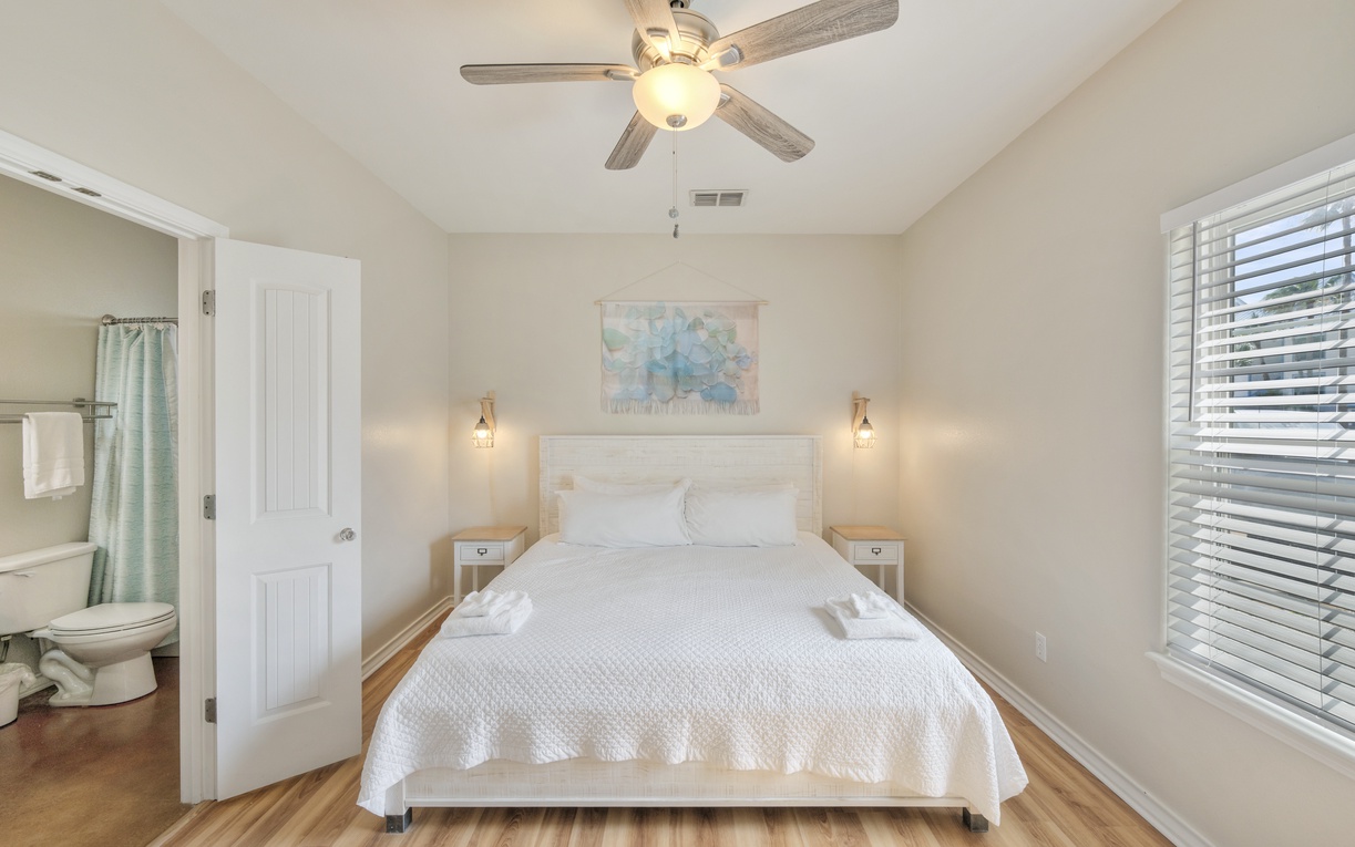Unwind in your peaceful bedroom, where crisp linens, soft lighting, and a ceiling fan create the perfect retreat after a day of adventure.