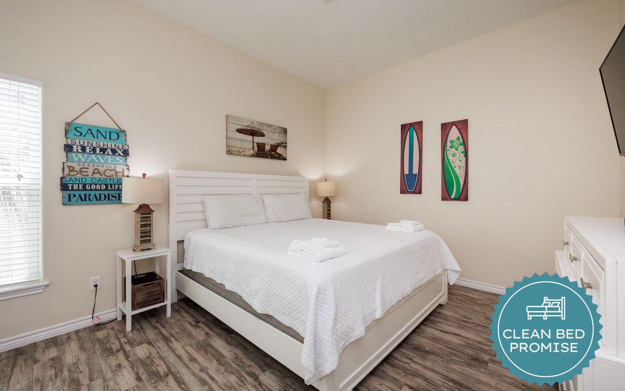 Drift off in your cozy coastal bedroom with beach-themed décor and crisp white linens that promise peaceful nights.